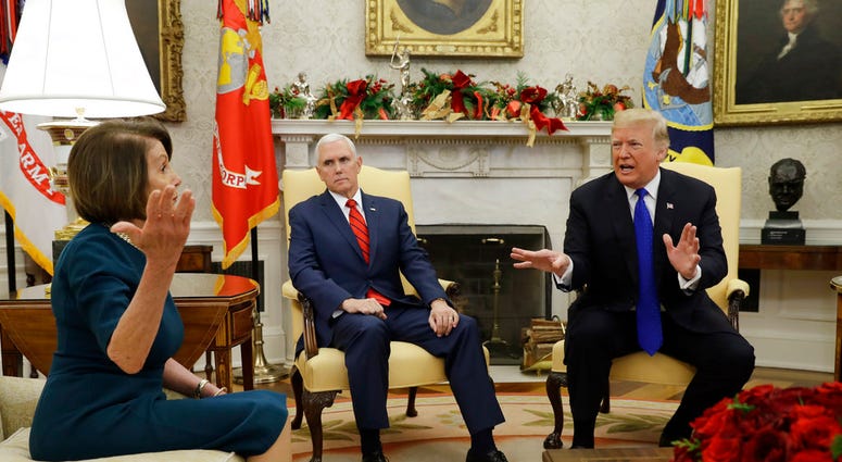 President Donald Trump and Vice President Mike Pence, meet with House Minority Leader Nancy Pelosi, D-Calif., left, and Senate Minority Leader Chuck Schumer, D-N.Y., not shown, in the Oval Office of the White House, Tue, Dec. 11, 2018, in Washington DC
