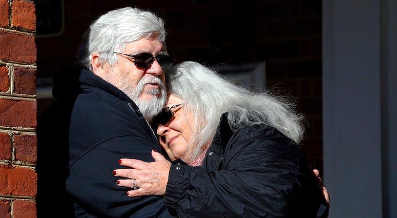 Susan Bro hugs her husband after jury recoommends life sentence in killing of the couple's daughter