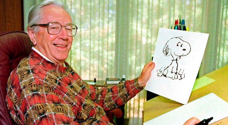 n this Feb. 12, 2000, file photo, cartoonist Charles M. Schulz displays a sketch of his beloved character "Snoopy" in his office in Santa Rosa, Calif. Apple has struck a deal with DHX Media to produce new “Peanuts” content