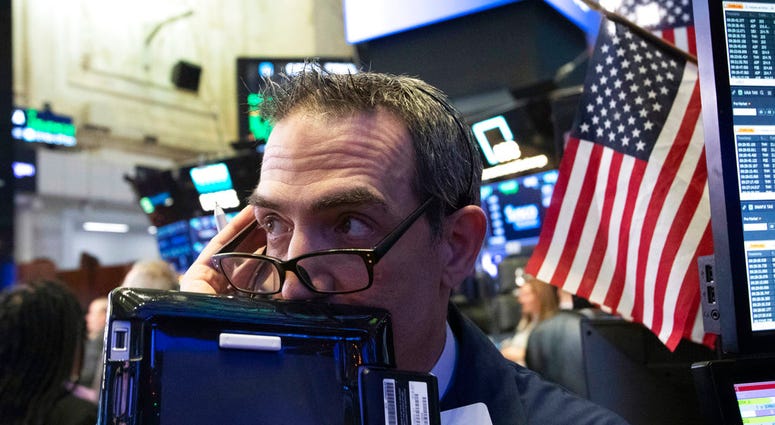 In this Dec. 12, 2018, file photo trader Gregory Rowe works at the New York Stock Exchange, Wednesday, Dec. 12, 2018, in New York. (AP Photo/Mark Lennihan, File)