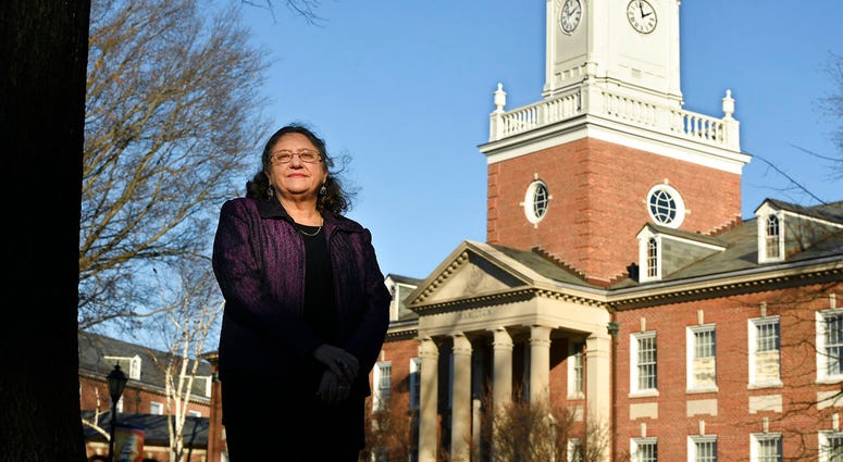 In this Tuesday, Dec. 18, 2018 photo, Michele Fitzpatrick, a retired lieutenant commander in the Coast Guard, poses for a photograph at the United States Coast Guard Academy in New London, Conn.