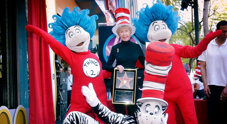 In this March 11, 2004 file photo, Audrey Geisel, widow of famed children's book author Theodor Seuss Geisel, better known as Dr. Seuss, poses with The Cat in the Hat, foreground, and Thing 1 and Thing 2, who are characters from his books,