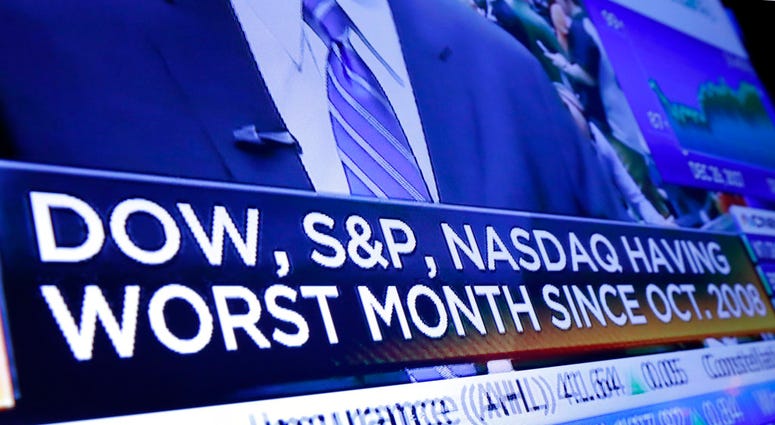 A headline appears on a television screen on the floor of the New York Stock Exchange, Wednesday, Dec. 26, 2018. (AP Photo/Richard Drew)