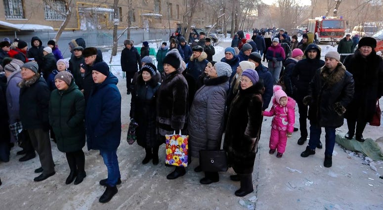 Locals gather outside building Magnitorgorsk, Russia