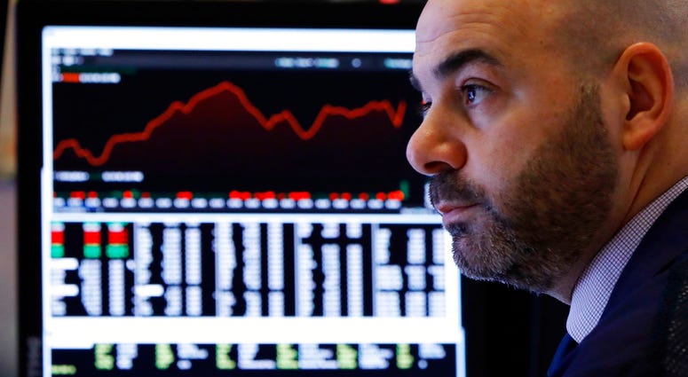 Trader Fred DeMarco works in a booth on the floor of the New York Stock Exchange, Wednesday, Jan. 2, 2019. (AP Photo/Richard Drew)