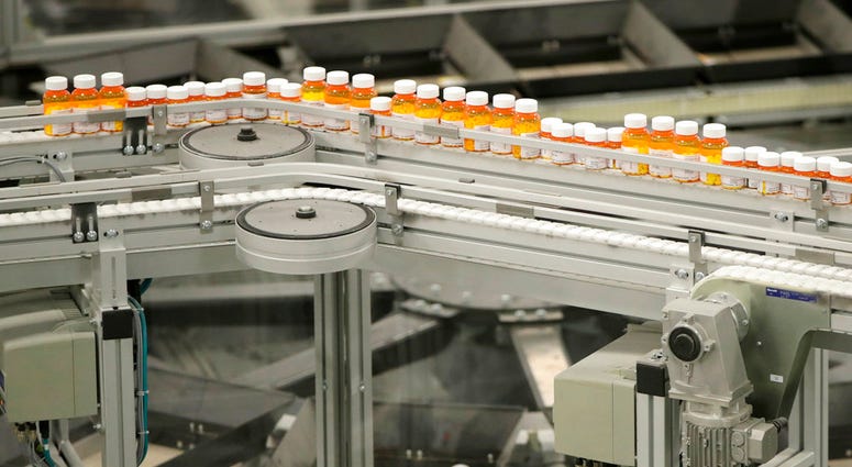 In this July 10, 2018 file photo, bottles of prescription medicines ride on a conveyor belt at a pharmacy warehouse in Florence, N.J.