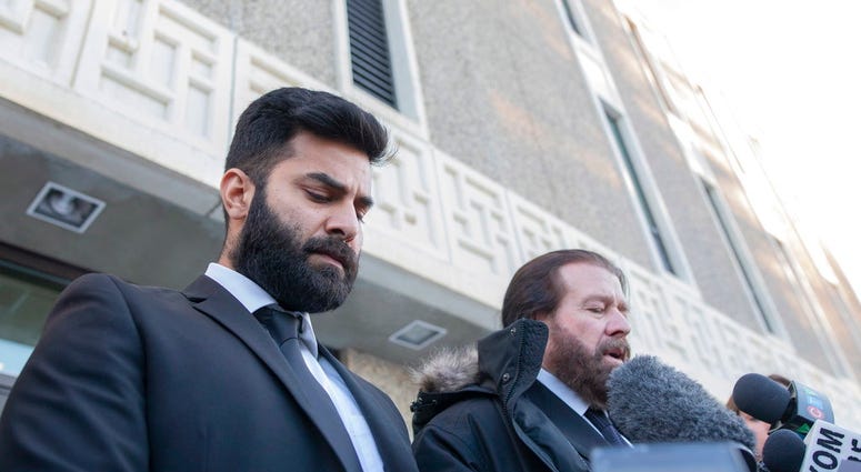 Jaskirat Singh Sidhu leaves court with his lawyer Mark Brayford, right, in Saskatchewan, Tue, Jan. 8, 2019. Sidhu, the driver of a transport truck involved in a bus crash that killed 16 people with the Humboldt Broncos junior hockey team