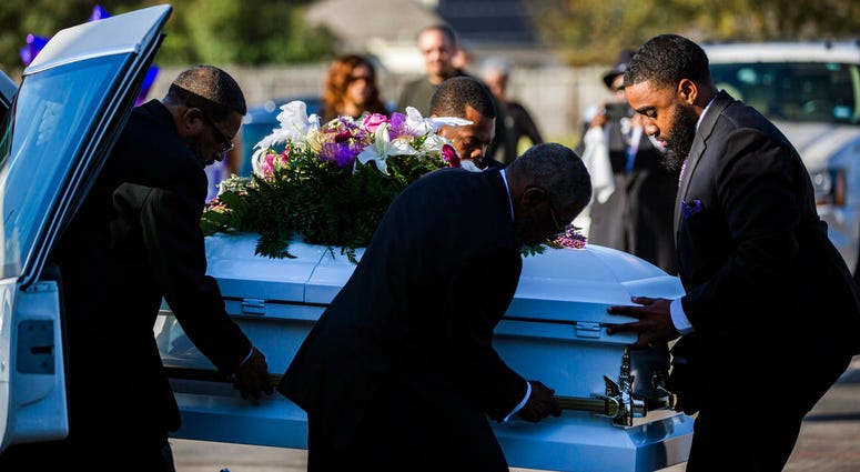The casket of Jazmine Barnes is removed from the funeral hearse to be taken inside the Community of Faith Church for a memorial service, Tuesday, Jan. 8, 2019, in Houston.
