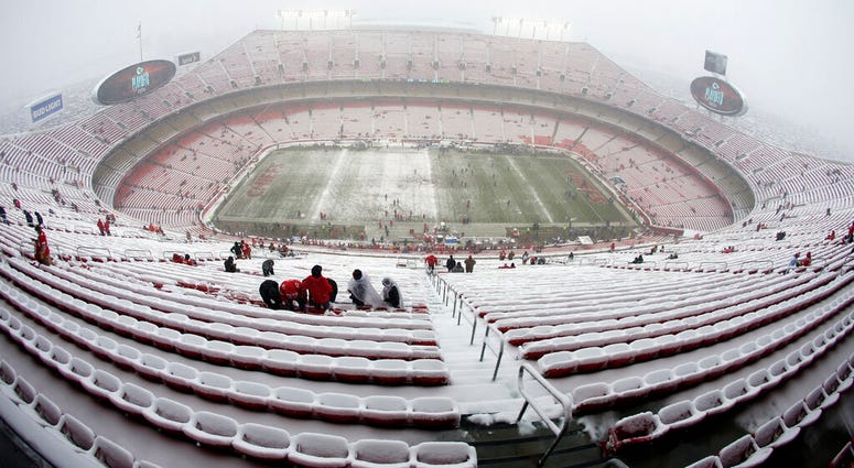 Fans arrive at a snow covered Arrowhead Stadium before an NFL divisional football playoff game between the Kansas City Chiefs and the Indianapolis Colts, in Kansas City, Mo., Saturday, Jan. 12, 2019