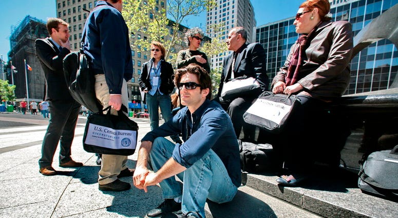 In this April 29, 2010 file photo, census employees, including Joseph Mintz, seated, and Lesley Rubinger, far right, assemble after a training course in New York.
