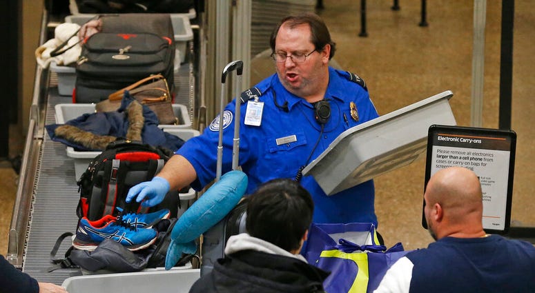A TSA worker helps passengers at the Salt Lake City International Airport Wednesday Jan., 16, 2019, in Salt Lake City. (AP Photo/Rick Bowmer) A TSA worker helps passengers at the Salt Lake City International Airport Wednesday Jan., 16, 2019, in Salt Lake City. (AP Photo/Rick Bowmer)