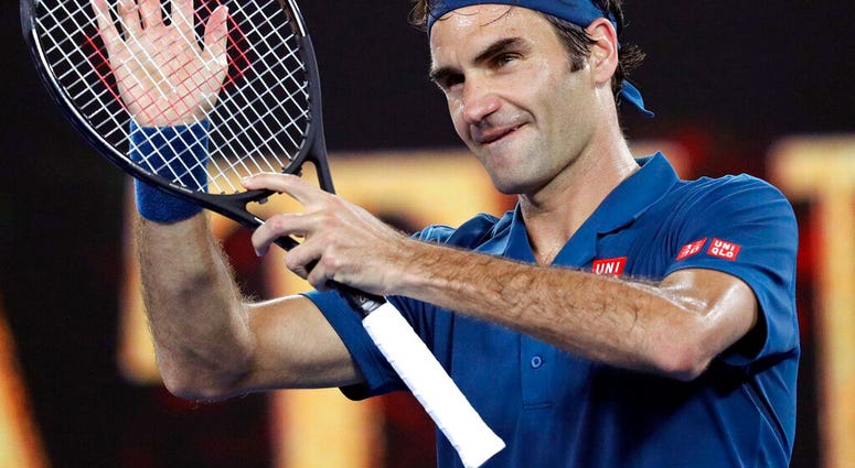 Switzerland's Roger Federer celebrates after defeating United States' Taylor Fritz during their third round match at the Australian Open tennis championships in Melbourne, Australia, Friday, Jan. 18, 2019.