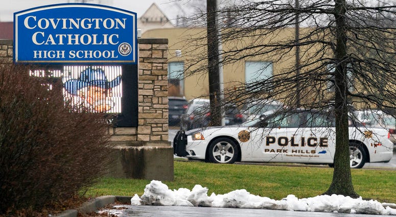 A police car sits at the entrance to Covington Catholic High School in Park Hills, Ky., Saturday, Jan 19, 2019. A diocese in Kentucky apologized Saturday after videos emerged showing students from the Catholic boys' high school mocking Native Americans