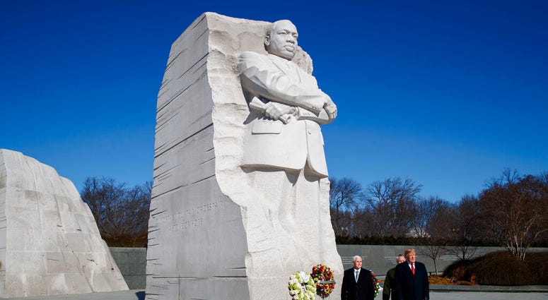 President Donald Trump, right, and Vice President Mike Pence, left, visit the Martin Luther King Jr. Memorial, Monday, Jan. 21, 2019, in Washington.