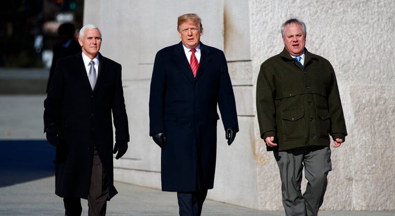 President Donald Trump, center, Vice President Mike Pence, left, escorted by Acting Interior Secretary David Bernhardt, right, Monday,Jan. 21, 2019, in Washington.