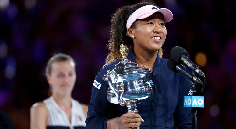 Japan's Naomi Osaka holds her trophy after defeating Petra Kvitova, left, of the Czech Republic during the women's singles final at the Australian Open tennis championships in Melbourne, Australia, Saturday, Jan. 26, 2019