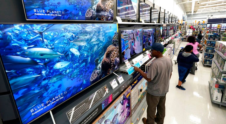In this Nov. 9, 2018, file photo shoppers look at televisions at a Walmart Supercenter in Houston, Texas