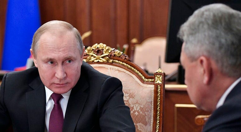 Russian President Vladimir Putin, left, speaks to Defense Minister Sergei Shoigu during a meeting in the Kremlin in Moscow, Russia, Saturday, Feb. 2, 2019