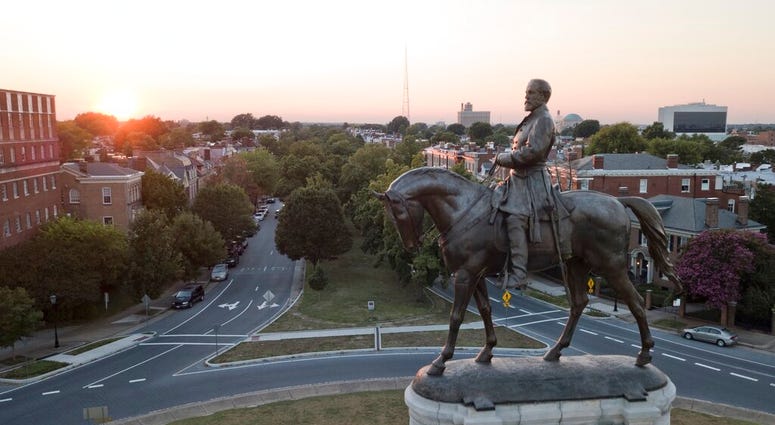 In this July 31, 2017 photo, the sun sets behind the statue of confederate General Robert E. Lee on Monument Avenue in Richmond, Va. (AP Photo/Steve Helber) In this July 31, 2017 photo, the sun sets behind the statue of confederate General Robert E. Lee on Monument Avenue in Richmond, Va. (AP Photo/Steve Helber)