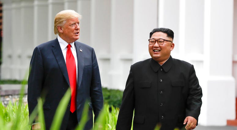 In this June 12, 2018, file photo, U.S. President Donald Trump, left, and North Korea leader Kim Jong Un walk from their lunch at the Capella resort on Sentosa Island in Singapore. (AP Photo/Evan Vucci, File)