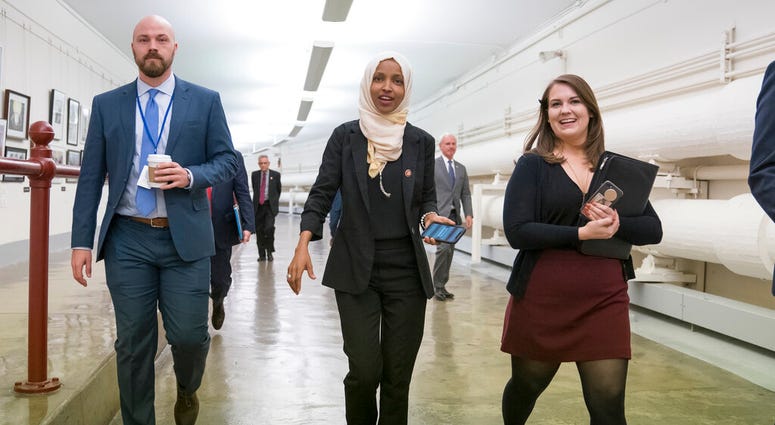 Representative Ilhan Omar (center) on Capitol Hill