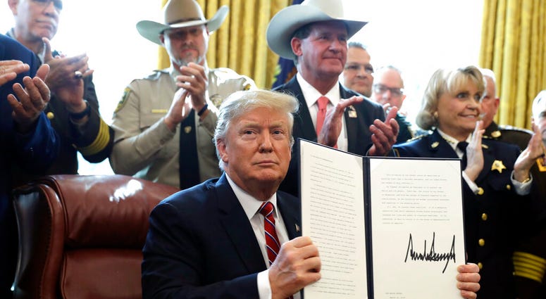 President Donald Trump speaks about border security in the Oval Office of the White House, Friday, March 15, 2019, in Washington. (AP Photo/Evan Vucci)