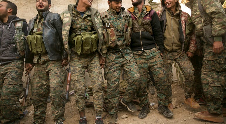 U.S.-backed Syrian Democratic Forces (SDF) fighters celebrate their territorial gains over Islamic State militants in Baghouz, Syria, move to a camp Tuesday, March 19, 2019. (AP Photo/Maya Alleruzzo) U.S.-backed Syrian Democratic Forces (SDF) fighters celebrate their territorial gains over Islamic State militants in Baghouz, Syria, move to a camp Tuesday, March 19, 2019. (AP Photo/Maya Alleruzzo)