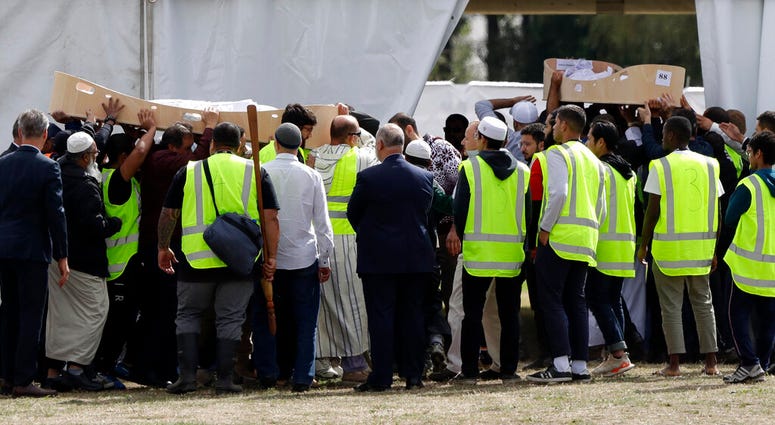 Mourners carry caskets of father and son in Christchurch