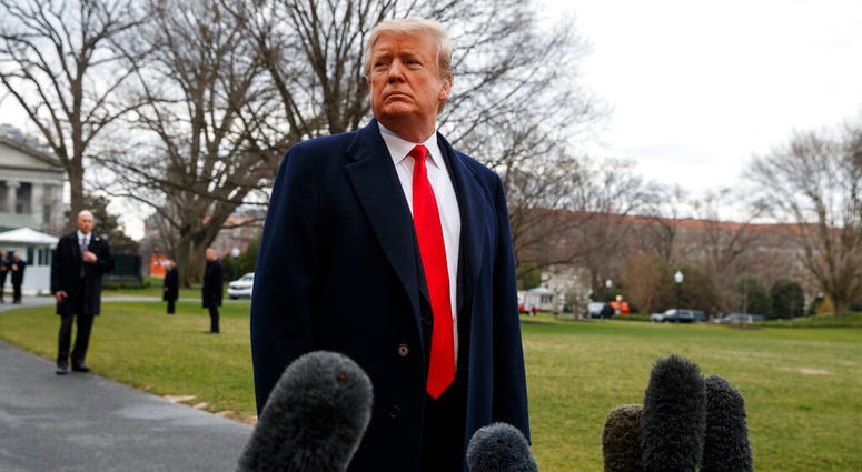 President Donald Trump listens to a question as he speaks with reporters before boarding Marine One on the South Lawn of the White House, Friday, March 22, 2019, in Washington. (AP Photo/Evan Vucci)