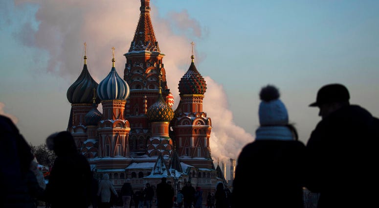 FILE - In this Thursday, Jan. 24, 2019 file photo, people walk in Red Square on a cold day, with St. Basil's Cathedral in the background, in Moscow, Russia. A senior Russian lawmaker on Monday March 25, 2019, has welcomed the findings of special counsel R