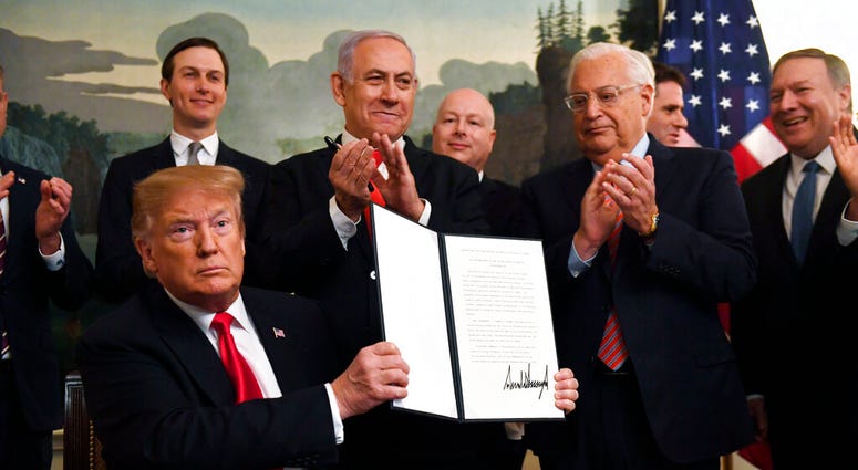 President Donald Trump holds up a signed proclamation recognizing Israel's sovereignty over the Golan Heights. (AP Photo/Susan Walsh) President Donald Trump holds up a signed proclamation recognizing Israel's sovereignty over the Golan Heights. (AP Photo/Susan Walsh)