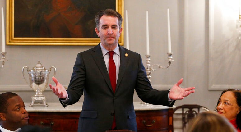 FILE - In this Friday, Feb. 22, 2019 file photo, Gov. Ralph Northam, center, greets members of the Richmond 34 and other African-American leaders for a breakfast at the Governors Mansion at the Capitol in Richmond, Va. (AP Photo/Steve Helber) FILE - In this Friday, Feb. 22, 2019 file photo, Gov. Ralph Northam, center, greets members of the Richmond 34 and other African-American leaders for a breakfast at the Governors Mansion at the Capitol in Richmond, Va. (AP Photo/Steve Helber)