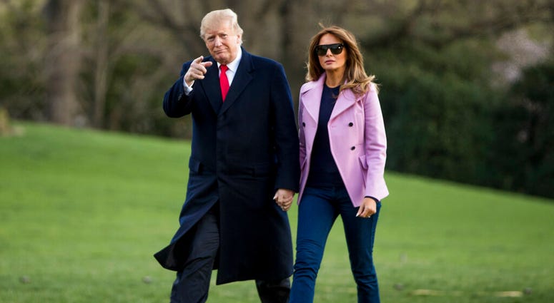 President Donald Trump and first lady Melania Trump walk along the South Lawn of the White House in Washington, Sunday, March 31, 2019. (AP Photo/Andrew Harnik)