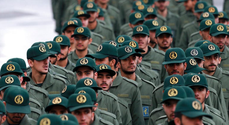 FILE - In this Feb, 11, 2019 file photo, Iranian Revolutionary Guard members arrive for a ceremony celebrating the 40th anniversary of the Islamic Revolution. (AP Photo/Vahid Salemi) FILE - In this Feb, 11, 2019 file photo, Iranian Revolutionary Guard members arrive for a ceremony celebrating the 40th anniversary of the Islamic Revolution. (AP Photo/Vahid Salemi)