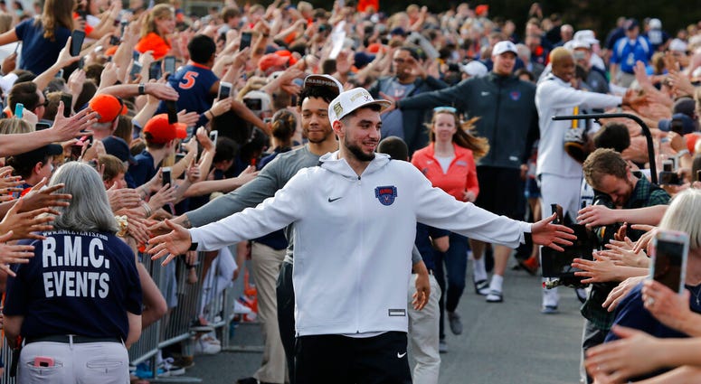Ty Jerome and other members of the Virginia basketball team are welcomed by fans as they return home after their win of the championship in the Final Four NCAA college basketball tournament. (AP Photo/Steve Helber) Ty Jerome and other members of the Virginia basketball team are welcomed by fans as they return home after their win of the championship in the Final Four NCAA college basketball tournament. (AP Photo/Steve Helber)