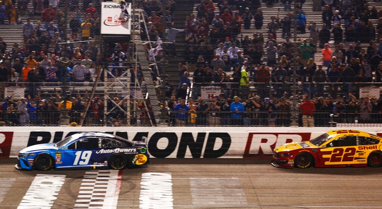 Martin Truex Jr. (19) crosses the finish line in front of Joey Logano (22) to win the NASCAR Cup Series auto race at Richmond Raceway in Richmond, Va., Saturday, April 13, 2019. (AP Photo/Steve Helber) Martin Truex Jr. (19) crosses the finish line in front of Joey Logano (22) to win the NASCAR Cup Series auto race at Richmond Raceway in Richmond, Va., Saturday, April 13, 2019. (AP Photo/Steve Helber)