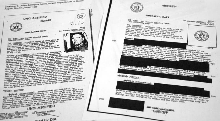 The redacted, right, and the unredacted versions of the biographical intelligence file report on Chilean dictator Augusto Pinochet from 1975 is photographed on April 15, 2019, in Washington. (AP Photo/Jon Elswick) The redacted, right, and the unredacted versions of the biographical intelligence file report on Chilean dictator Augusto Pinochet from 1975 is photographed on April 15, 2019, in Washington. (AP Photo/Jon Elswick)