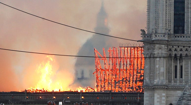 Flames rise from Notre Dame cathedral as it burns in Paris, Monday, April 15, 2019.