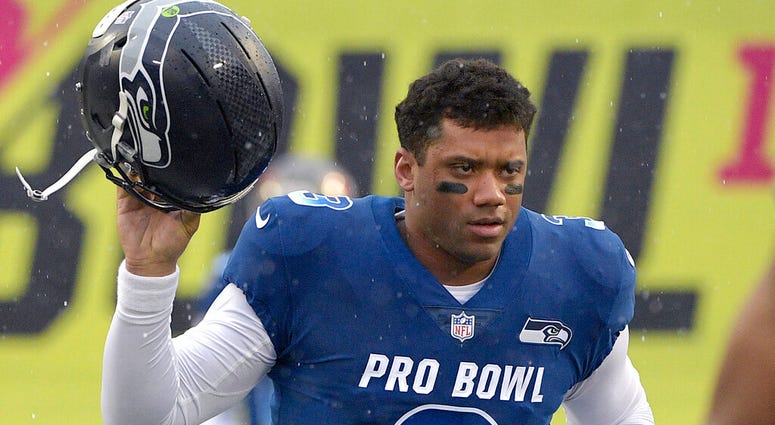 NFC quarterback Russell Wilson of the Seattle Seahawks runs onto the field during player introductions before the NFL Pro Bowl football game against the AFC in Orlando, Fla. (AP Photo/Phelan M. Ebenhack, File) NFC quarterback Russell Wilson of the Seattle Seahawks runs onto the field during player introductions before the NFL Pro Bowl football game against the AFC in Orlando, Fla. (AP Photo/Phelan M. Ebenhack, File)