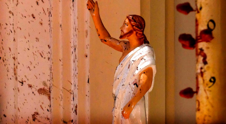 Blood Stains on the wall near Jesus Christ Statue Blood stains are seen on the wall and on a Jesus Christ statue at the St. Sebastian's Church after blast