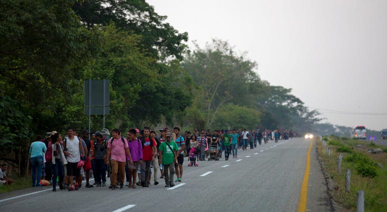 Central American migrants traveling in a caravan to the U.S. border walk on a road in Pijijiapan, Mexico, Monday, April 22, 2019. (AP Photo/Moises Castillo)