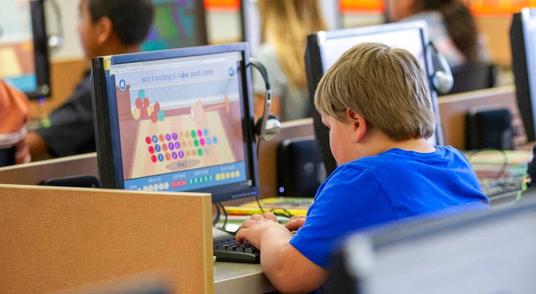 FILE - In this Oct. 29, 2018 file photo, students work on computers at an elementary school in Beaver, Utah. (Scott G Winterton/The Deseret News via AP) FILE - In this Oct. 29, 2018 file photo, students work on computers at an elementary school in Beaver, Utah. (Scott G Winterton/The Deseret News via AP)