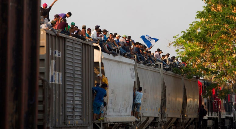 Central American migrants ride atop a freight train during their journey toward the U.S.-Mexico border, in Ixtepec, Oaxaca State, Mexico, Tuesday, April 23, 2019. (AP Photo/Moises Castillo)