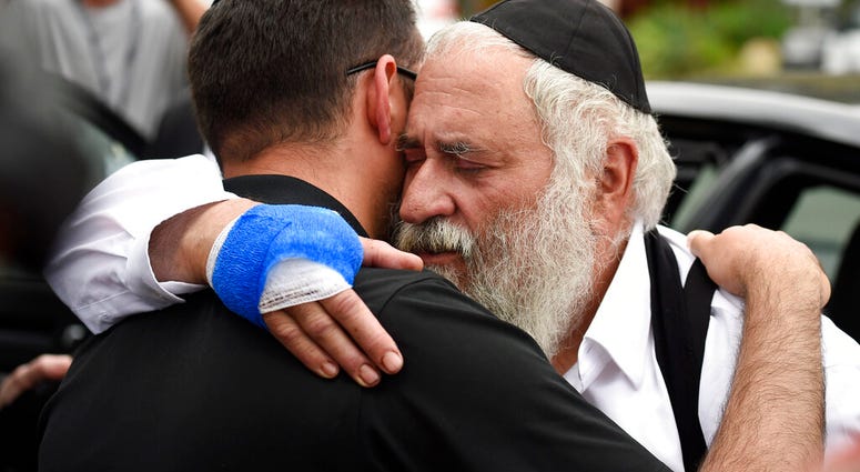 RabbiYisroel Goldstein comforts synagogue member