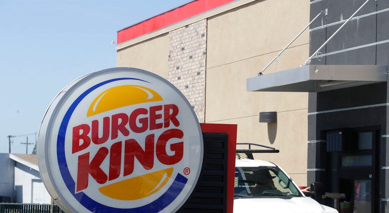In this Thursday, April 25, 2019, photo a customer takes his order from the drive through window at a Burger King in Redwood City, Calif. (AP Photo/Jeff Chiu) In this Thursday, April 25, 2019, photo a customer takes his order from the drive through window at a Burger King in Redwood City, Calif. (AP Photo/Jeff Chiu)