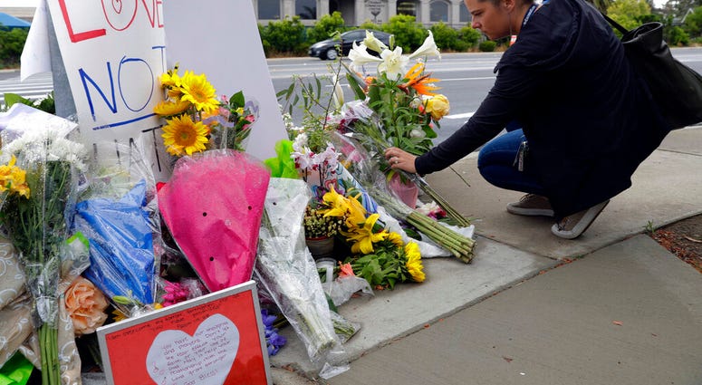 A woman leaves flowers on a growing memorial across the street from the Chabad of Poway synagogue in Poway, Calif., on Monday, April 29, 2019. (AP Photo/Greg Bull) A woman leaves flowers on a growing memorial across the street from the Chabad of Poway synagogue in Poway, Calif., on Monday, April 29, 2019. (AP Photo/Greg Bull)