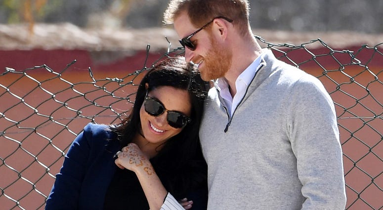 In this Sunday, Feb. 24, 2019 file photo, Britain's Prince Harry and Meghan, Duchess of Sussex, watch children playing football at a school in the town of Asni, in the Atlas mountains, Morocco. (Facundo Arrizabalaga/Pool via AP, File)