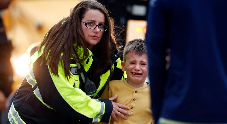 Officials guide students off a bus and into a recreation center where they were reunited with their parents after a shooting at a suburban Denver middle school Tuesday, May 7, 2019, in Highlands Ranch, Colo. (AP Photo/David Zalubowski) Officials guide students off a bus and into a recreation center where they were reunited with their parents after a shooting at a suburban Denver middle school Tuesday, May 7, 2019, in Highlands Ranch, Colo. (AP Photo/David Zalubowski)