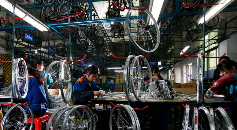 Chinese workers in a bike factory