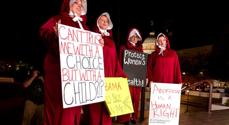 Protesters dressed as handmaids outside Capitol in Montgomery